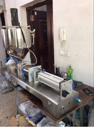 Picture of paste filling machine with the heated and mixer hopper 5-50ml